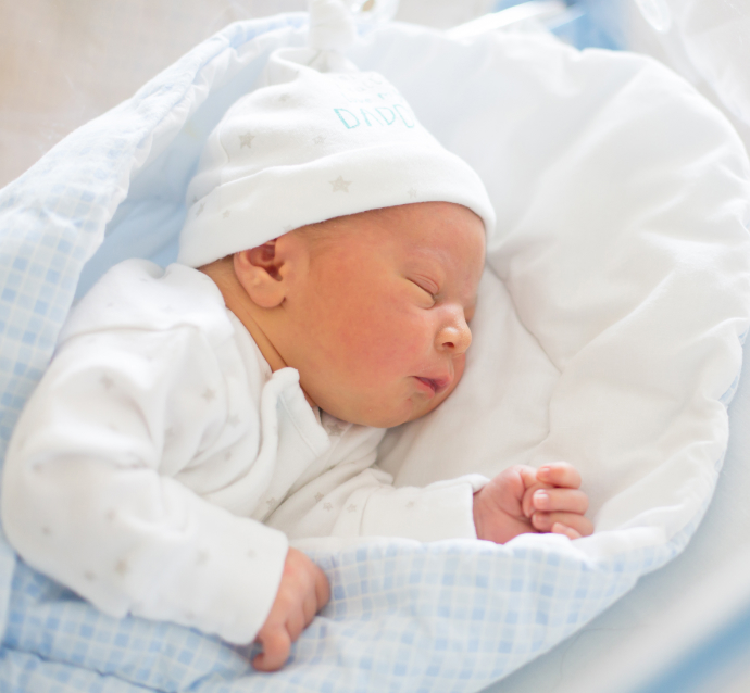 Gentle image of a newborn infant sleeping peacefully in a white crib, representing the hope and promise of a healthy future.  Ensuring this bright future for your child includes addressing potential birth injuries should they unfortunately occur. A knowledgeable birth injury attorney is available to help families navigate the legal and emotional challenges that can arise following a birth injury.
